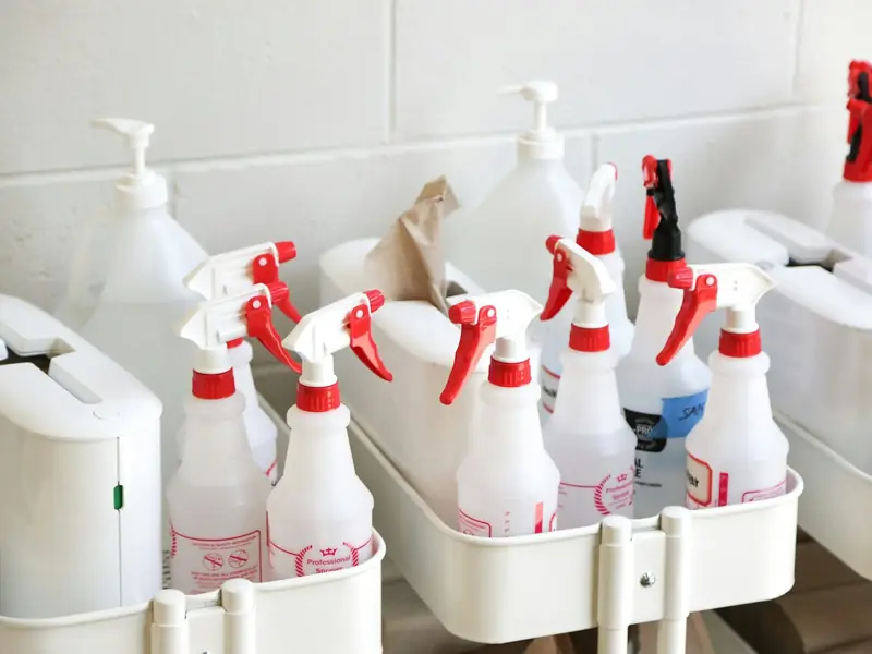 Caddies of spray bottles and cleaning supplies ready for the day