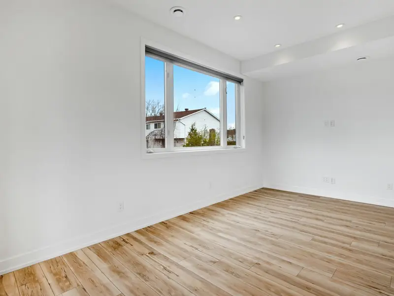 Empty room with clean wood floors, ready for move-in