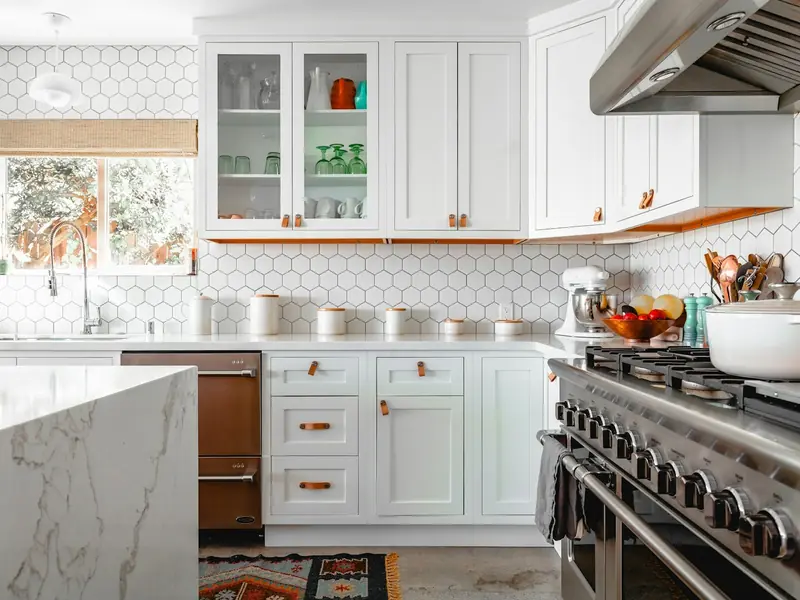 Bright white kitchen with spotless counters and a marble island